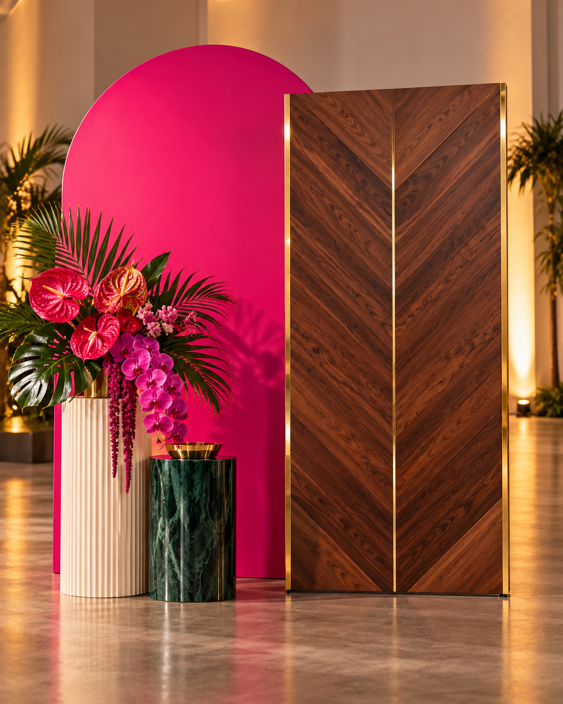 Walnut chevron photo moment panel styled with a hot pink arch and tropical floral decor